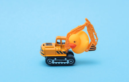 Excavator with a rubber duck on a blue background