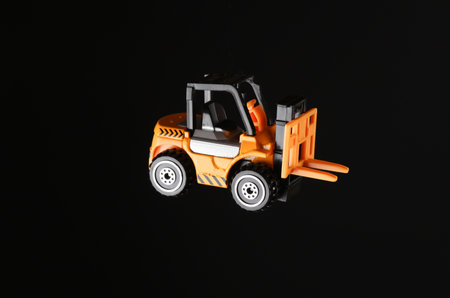 Toy forklift isolated on black background