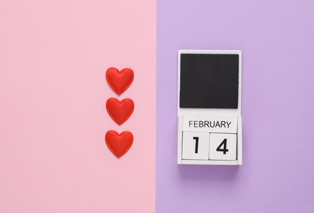 February 14 wooden calendar with hearts on pastel background. Valentine's Dayの写真素材