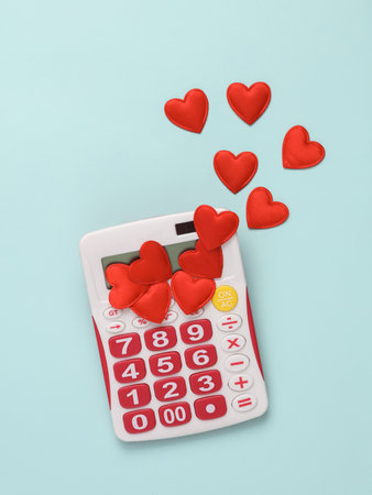 Calculator with hearts on a blue background. Business, love, valentine's day conceptの写真素材