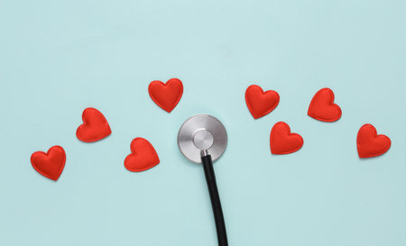 Stethoscope with hearts on a blue background. Love concept, diagnosis of heart disease