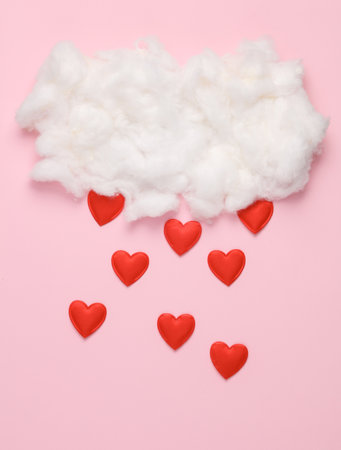 Cloud with falling hearts on pink background. Romantic, love, valentine's day conceptの写真素材