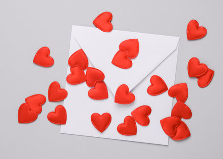 White envelope with a heart on gray background. Love, romance, valentine's day, February 14 concept