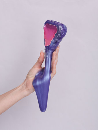 Woman's hand with a slime on a gray backgroundの写真素材