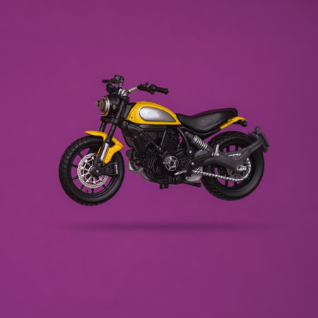 Toy motorcycle levitating on purple background with shadowの写真素材