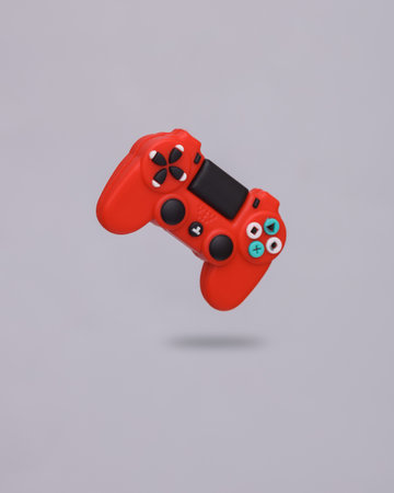 Miniature red gamepad levitating on a gray background