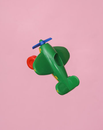 Toy airplane with propeller isolated on pink background