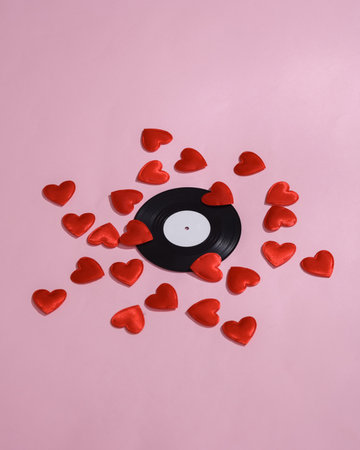 Vinyl record with hearts on a pink background. Love concept, valentine's day, february 14th celebration, creative layoutの写真素材