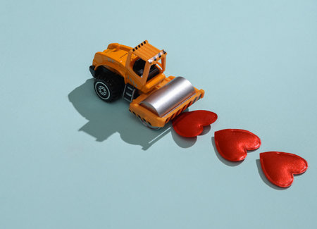 Toy paver model with hearts on blue background. Love concept, valentine's day, february 14th celebration, creative layoutの写真素材