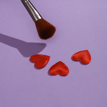 Makeup brush with hearts on pastel background. Valentine's day, love conceptの写真素材