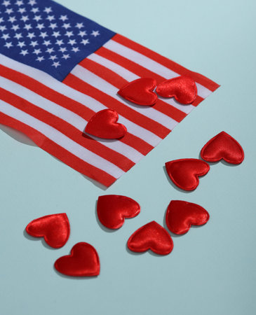 Patriotism. USA flag and hearts on a blue background