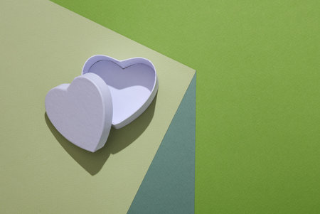 White box in a heart shape on a paper cube. optical illusion. geometric composition. minimalist creative layoutの写真素材