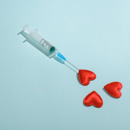 Syringe with hearts on a blue backgroundの写真素材
