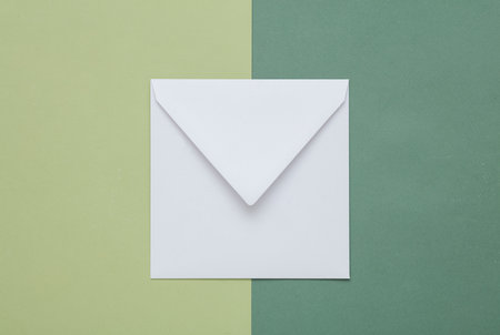 White blank envelope on a green background