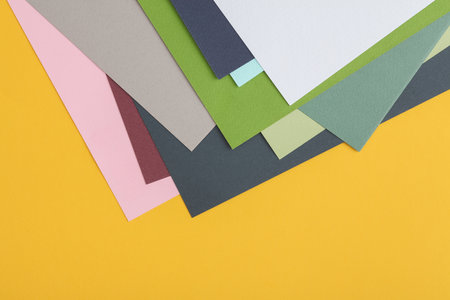 Colored sheets of paper for creativity on a yellow background