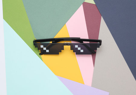 8 bit pixelated sunglasses on colored background