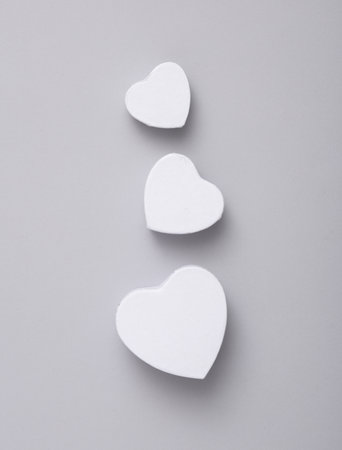 White heart shaped gift boxes mockup isolated on gray background. top viewの写真素材