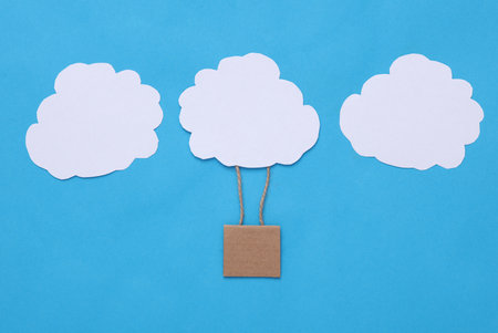 children's creativity. Flying hot air balloon with clouds on a blue background. dream conceptの写真素材
