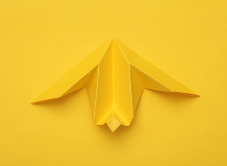 Origami airplane mockup on yellow backgroundの素材 [FY310199727870]