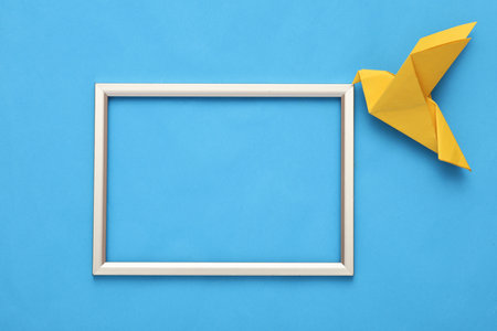 Peace in Ukraine. Yellow dove on a blue background with empty frame.の写真素材