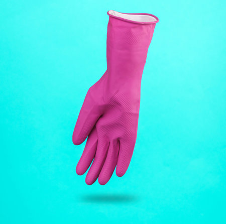 Purple cleaning rubber glove levitating on blue background with a shadow. cleaning conceptの写真素材