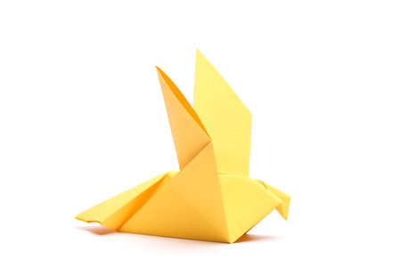 Yellow origami dove isolated on white background. peace symbolの写真素材