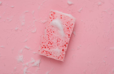Sponge with foam on a pink background. cleaning conceptの写真素材