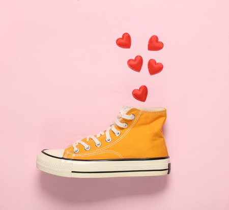 Sneaker with hearts on pink background. Valentine's Day. creative layoutの写真素材