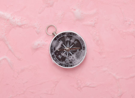 Compass in foam on pink backgroundの写真素材