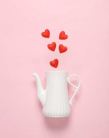 Teapot with hearts on pink background. Valentine's Day. creative layoutの写真素材