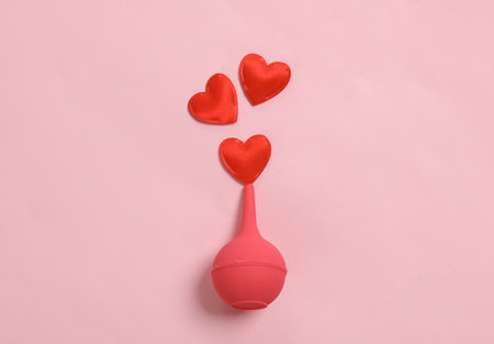Enema with hearts on pink background. Valentine's Day. love concept. creative layoutの写真素材