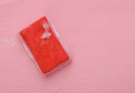 Sponge with foam on a pink background. cleaning conceptの写真素材