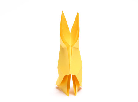 Yellow paper origami rabbit isolated on white backgroundの写真素材