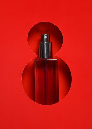 World Women's Day. Hole paper space in the shape of the number 8 and perfume bottleの写真素材