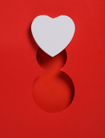 World Women's Day. Hole paper space in the shape of the number 8 and heart