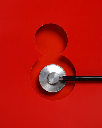 Hole paper space in the shape of the number 8 and stethoscopeの写真素材