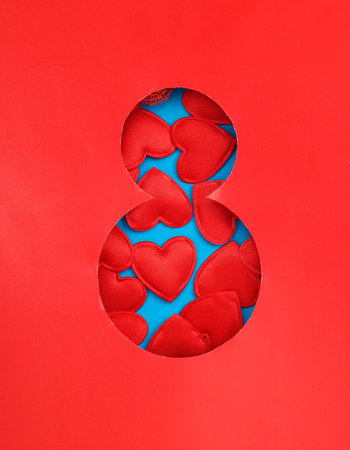 World Women's Day. Hole paper space in the shape of the number 8 with red heartsの写真素材