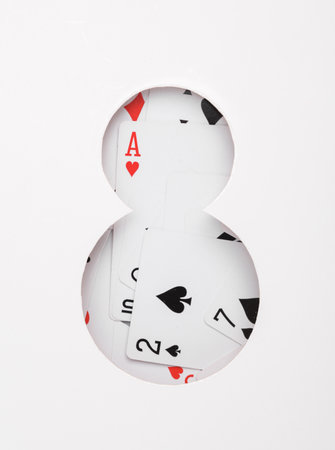 Number 8 from cut paper with playing cards. Gambling concept
