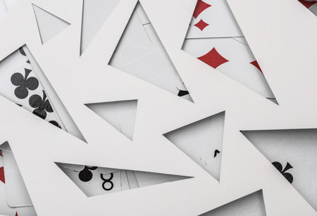 Abstract background with playing cards and paper cut triangles