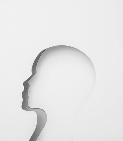 Cut paper in the shape of human face. mental health conceptの写真素材