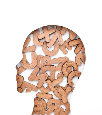 Human face cut out of paper hole with letters on white background
