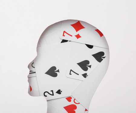 Human head from cut paper with playing cards. Gambling conceptの写真素材