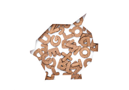 Piggy bank cut out of paper hole with letters on white backgroundの写真素材