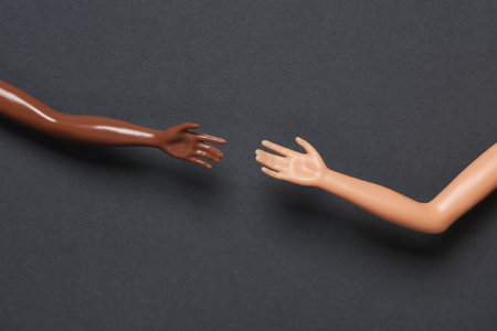 Doll hands on a gray background. Help, friendship conceptの写真素材