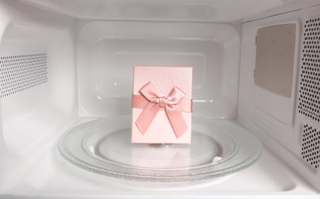 Gift box inside a microwave oven close-up