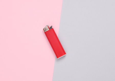 Red lighter on a gray-pink backgroundの写真素材