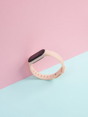 Creative layout of a modern smart bracelet on a pastel backgroundの写真素材