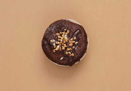 Chocolate Cupcake on brown background. top view. flat lay