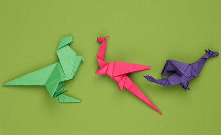 Origami dragons on a green backgroundの写真素材
