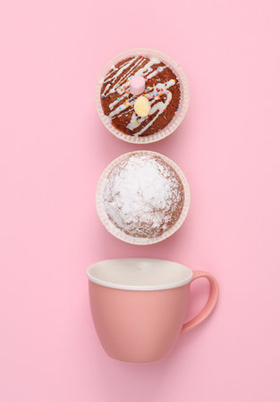 ceramic cup with muffins on pink backgroundの写真素材